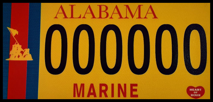 New Alabama Marine License Plate image - red on blue stripes at the left overlaid with the famous Iwo Jima image of Marines raising the flag; yellow background with black plate number and red lettering at the top (Alabama) and bottom (Marine); also a small red "Heart of Dixie" symbol in the bottom right corner